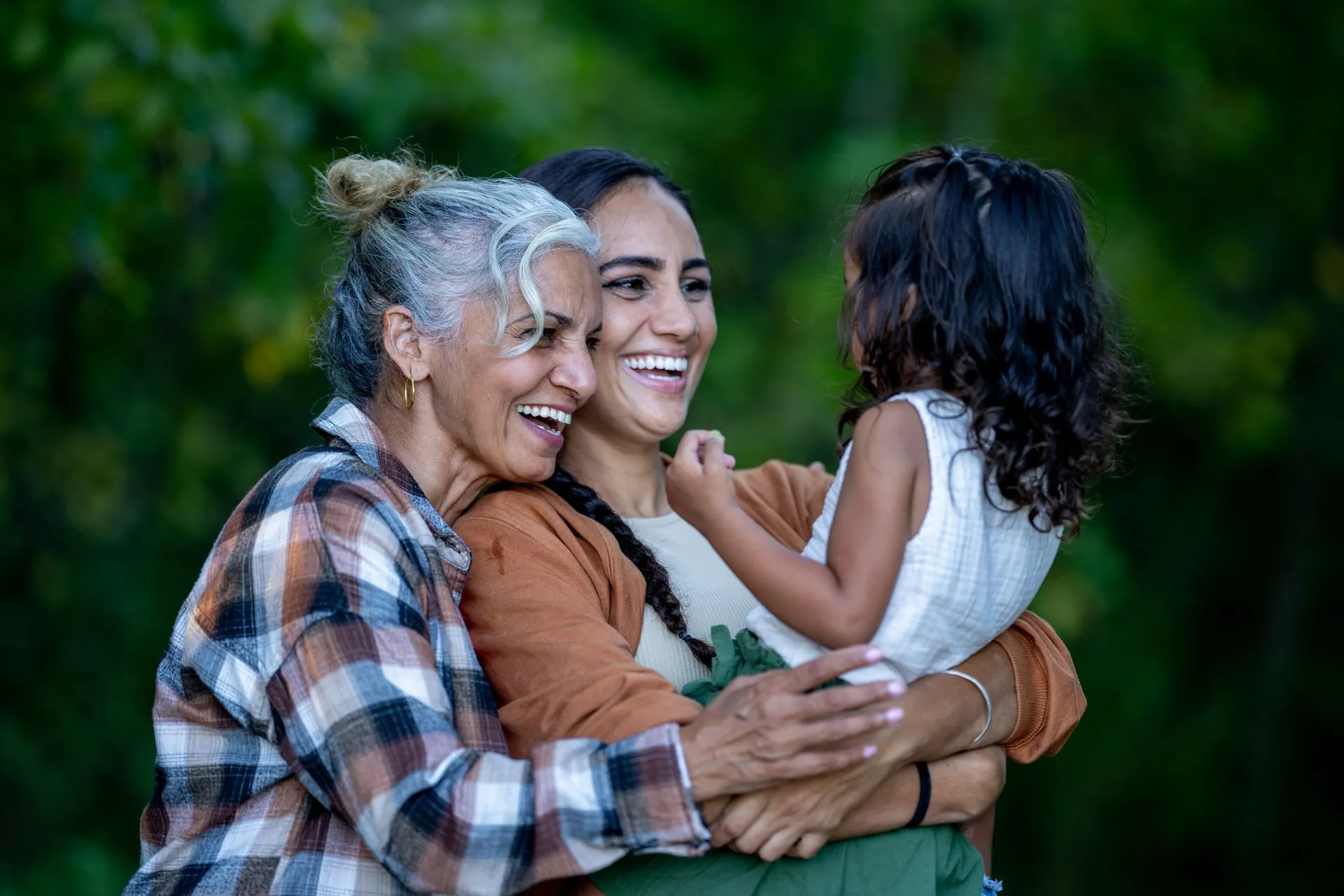 A multigenerational family laughing together, connected through clear hearing