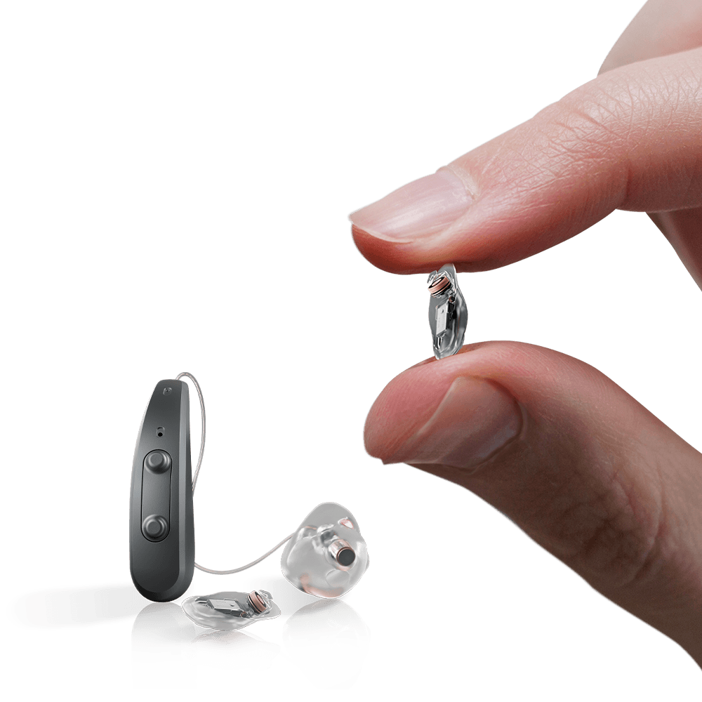 The three components of the Earlens system held in a hand