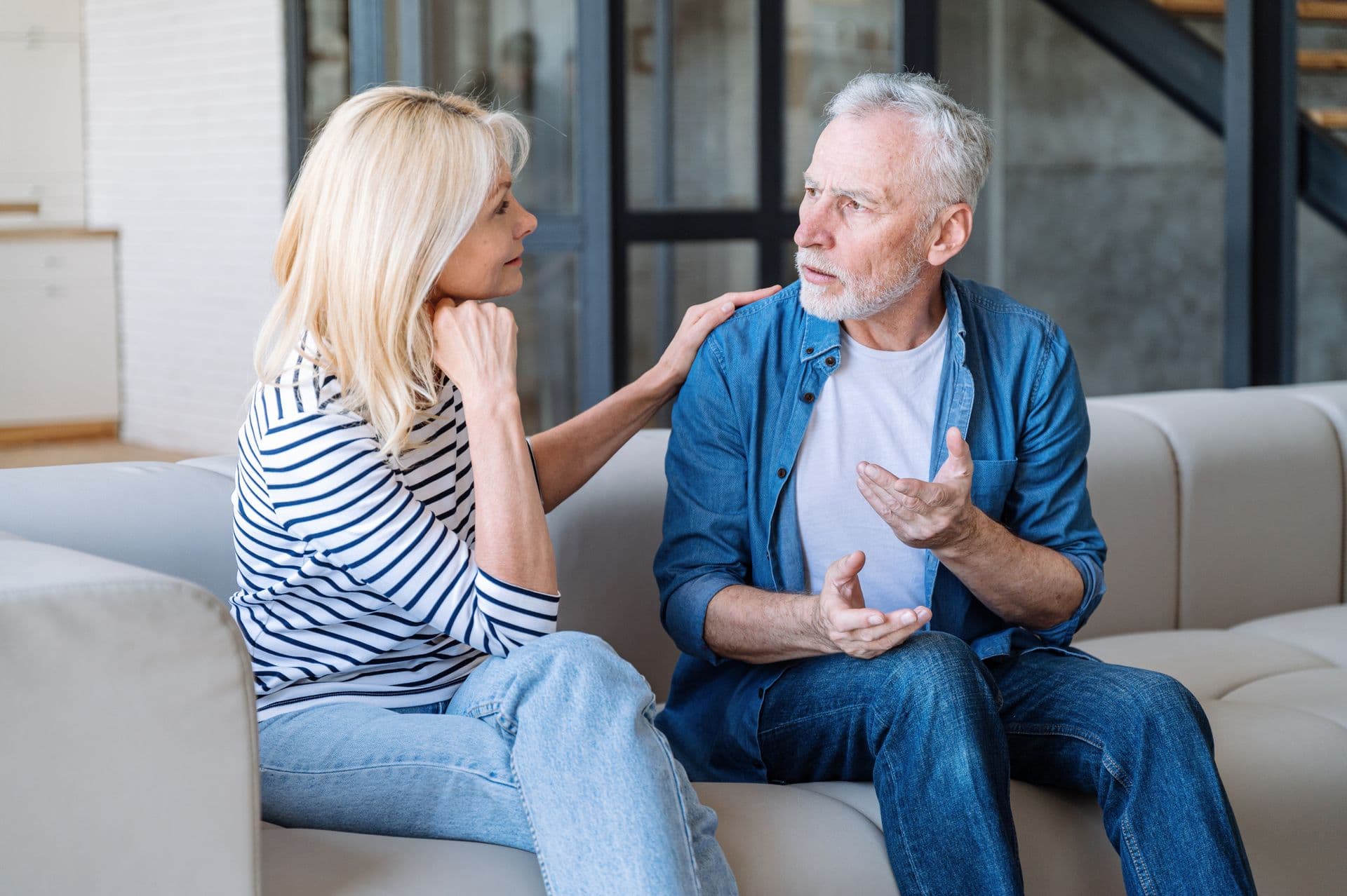 A husband sharing a quiet, concerned moment with his wife